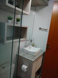 a bathroom with a sink and a toilet at Apto Aconchego da Serra - Bairro Maria Goretti in Bento Gonçalves +30 photos