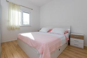 Postel nebo postele na pokoji v ubytování Apartmani Meriko