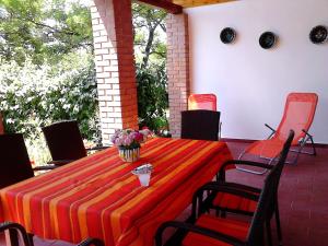 a table with a striped table cloth on a patio at Tiszavirág Vendégház in Tiszabábolna