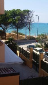 a view of the ocean from the balcony of a house at Sicilia Mare Apartments in San Leone