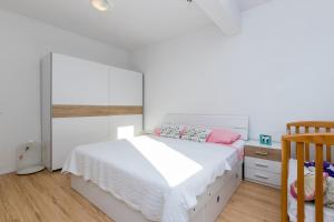 Postel nebo postele na pokoji v ubytování Apartmani Meriko