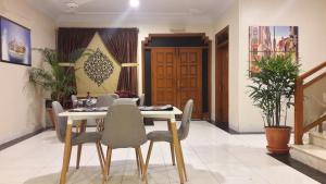 a dining room with a table and chairs at Hotel Seven 7 in Karachi