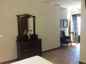 a bedroom with a dresser and a mirror on a wall at Casa da Torre in Valga