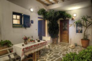 a room with a table and a dog laying on the floor at Ragoussis House in Logaras