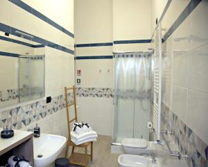 un bagno con doccia, lavandino e WC di Gemini Suite a Salerno