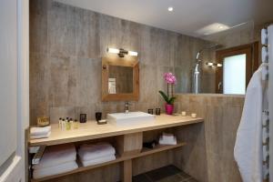 a bathroom with a sink and a mirror at Chalet Zebra in Méribel +26 photos