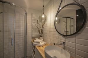 a bathroom with a sink and a mirror at ApartWisła in Wisła