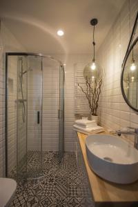a bathroom with a shower and a sink and a tub at ApartWisła in Wisła