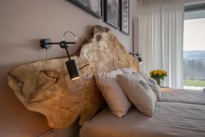 a bed with a large rock on the wall at ApartWisła in Wisła