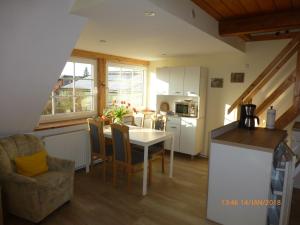 a kitchen and dining room with a table and chairs at Ferienhof Lorenzen in Dörphof