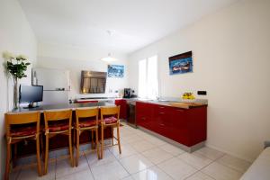 a kitchen with red cabinets and a counter top at Casa Cristina in Montale