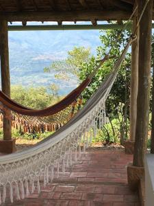 a hammock hanging from a pergola at Finca San Pedro in Barichara