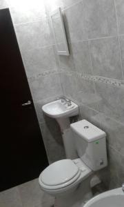 a bathroom with a toilet and a sink at Mendoza de sol in Villa Nueva