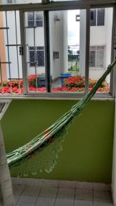 a large umbrella laying on the ground in front of a window at Apartamento Feliz in Aracaju