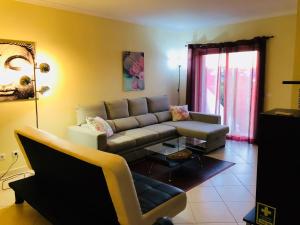 a living room with a couch and a table at Albufeira Luxury Villa in Albufeira