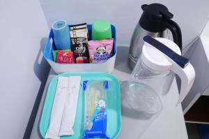 a table with a container of utensils and a blender at We Love B&B in Anping