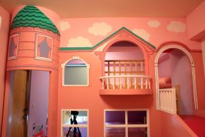 a room with a castle themed play room with a large mirror at We Love B&B in Anping