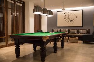 a living room with a pool table and a couch at The Villa by Contemporary Ceylon in Wadduwa