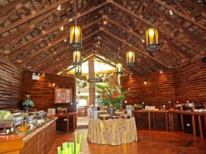 a restaurant with wooden ceilings and a table in a room at Sunset Park Resort And Spa - SHA Plus in Na Jomtien