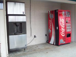a coke machine and a cocacola refrigerator in a room at Relax Inn Savannah in Savannah