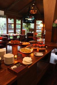 a large wooden table with plates of food on it at Gardenia Resort and Spa in Pontianak