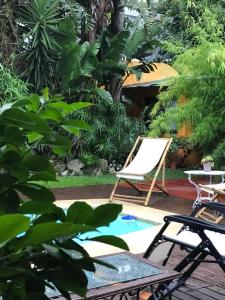 a patio with a chair and a pool at Casa Bambu, alquiler de corta estadia in Ciudad de la Costa