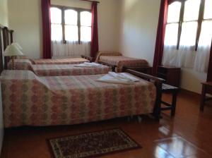מיטה או מיטות בחדר ב-Hostería Don Arturo