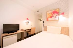 Un pat sau paturi într-o cameră la Hotel Plumm