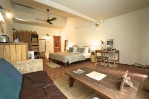 a living room with a bed and a table at iRoHa Garden Hotel & Resort in Phnom Penh