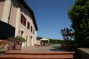 a courtyard of a building with a gazebo at Villa Gilda in Bracciano +48 photos