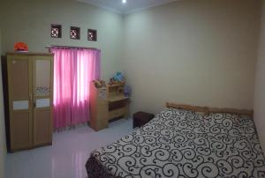 Postel nebo postele na pokoji v ubytování Wildan Homestay