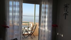a room with a table and a view of the ocean at Résidence TROUVILLE in Châtelaillon-Plage