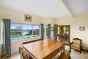 a dining room with a wooden table and a large window at Lemon Grove in Montville