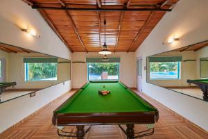 a large room with a pool table in it at Acorn Hideaway Resort & Spa in Rāmnagar
