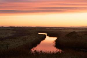 a view of a river at sunset at Tolly House in Wells next the Sea