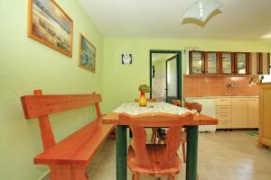 a kitchen with a wooden table and a dining room at Stone House Oreb`s Cottage in Vela Luka +98 photos