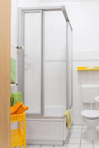 a white bathroom with a shower and a toilet at Ferienwohnung Wideystrasse in Witten