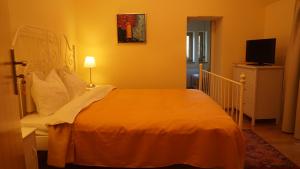 a bedroom with a bed and a television in it at Vila Arizto in Sinaia +28 photos
