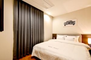 Postel nebo postele na pokoji v ubytování Blanc Business Hotel