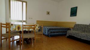 a living room with a bed and a couch and chairs at Villetta Patitari in Gallipoli +25 photos