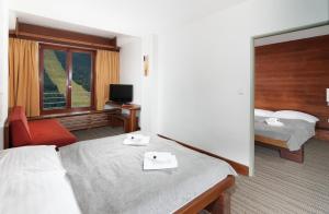 Letto o letti in una camera di Hotel Adam