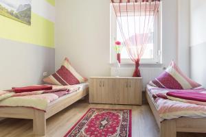 2 camas en una habitación con ventana y alfombra en Ferienwohnung, en Witten