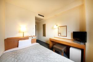 Postel nebo postele na pokoji v ubytování Shonandai Daiichi Hotel Fujisawa Yokohama