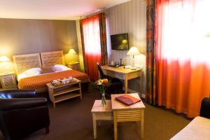 Un ou plusieurs lits dans un hébergement de l'établissement Almoria Hôtel & SPA