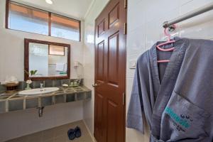 a bathroom with a sink and a blue towel at Pinnacle Samui Resort in Mae Nam