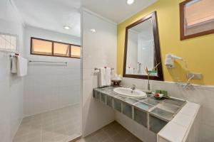 a bathroom with a sink and a mirror at Pinnacle Samui Resort in Mae Nam