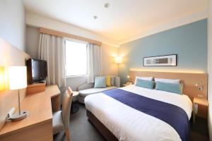 Postel nebo postele na pokoji v ubytování Shonandai Daiichi Hotel Fujisawa Yokohama