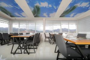 a conference room with tables and chairs and windows at Grand Dost Hotel in Osmancık
