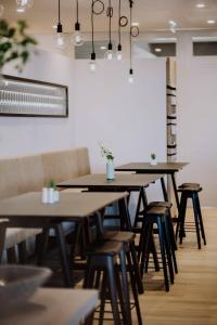 a row of tables and chairs in a restaurant at Apartment-Hotel Schaffenrath in Salzburg