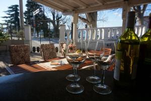 a table with two wine glasses and a bottle of wine at Apartments Ivančić in Novi Vinodolski